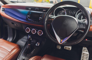 Dark luxury car Interior - steering wheel, shift lever and dashboard. Car interior luxury. Beige...