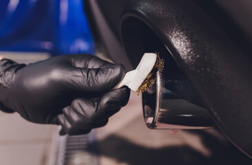 Car exhaust pipe with soap. Car wash background. brushing