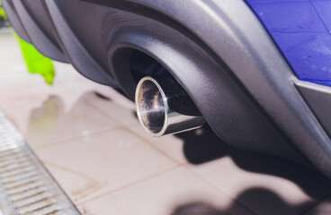 Car exhaust pipe with soap. Car wash background. close-up