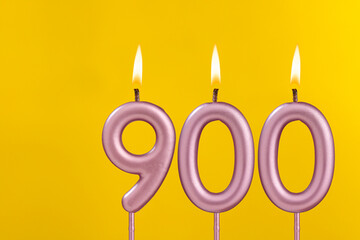 Birthday candle number 900 - Birthday celebration on yellow background