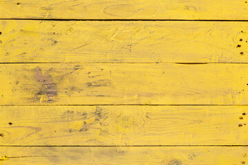 Weathered yellow wood texture background. Yellow stained wooden billboard close-up. Horizontal direction boards. Wavy pattern of wood fibers. - obrazy, fototapety, plakaty