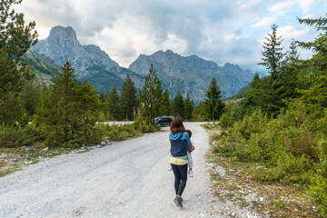 A young woman with her son walking on a trail in the Valbona valley, Theth national park, Albanian Alps, Valbona Albania