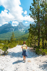 Woman hikers walking on Valbona Valley trail next to trees, Theth National Park, Albanian Alps, Albania