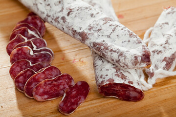 Slicing delicious Spanish smoked sausage fuete. High quality photo