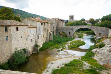 Fototapeta na wymiar View of medieval stone arched bridge of Benedictine Abbey Sainte-Marie d'Orbieu in Lagrasse