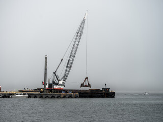 Large Crane Dredging the Winchester Bay along the Oregon coast.