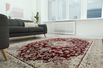 Cozy room interior with stylish furniture and soft carpet with beautiful pattern