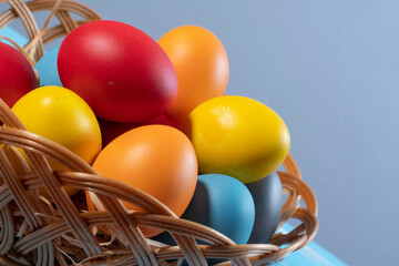 easter basket with straw and colored eggs