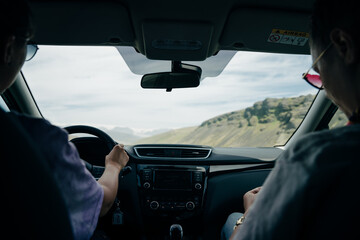 Driving in iceland, long road with mountains. Iceland road trip, view from car.