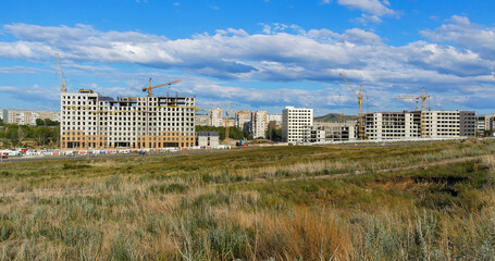 Views of the city of Ust-Kamenogorsk (kazakhstan). New residential area. Apartment buildings under construction. Autumn. Urbanization
