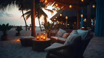 Foto op Plexiglas cozy Luxury resort, evening beach, candles blurred light on table ,sofa, hammock on front sunset sea ,tropical plan and palm © Aleksandr