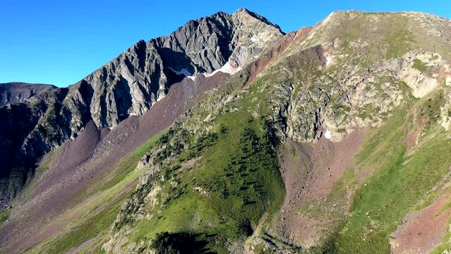 Drone shot, drone video, drone flight, aerial view, flight, mountain world near Aragnouet in the Pyrenees in the light of the rising sun, camera pans to snow-covered mountain peaks, Cap de Long