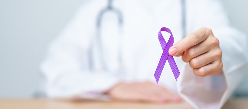 Doctor holding purple Ribbon for Violence, Pancreatic, Esophageal, Testicular cancer, Alzheimer, epilepsy, lupus, Sarcoidosis and Fibromyalgia. Awareness month and World cancer day concept