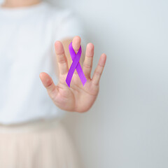 Woman holding purple Ribbon for Violence, Pancreatic, Esophageal, Testicular cancer, Alzheimer,...