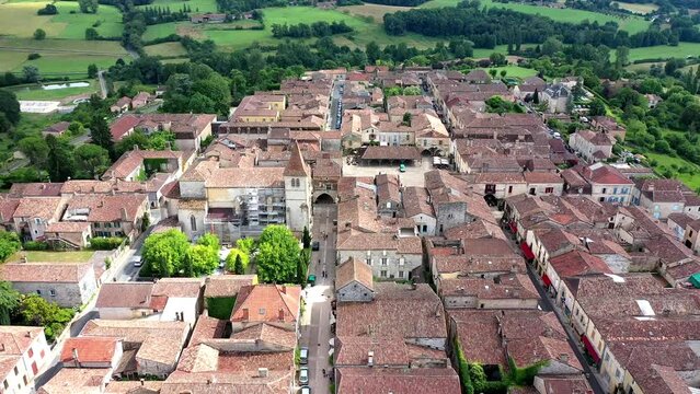 Drone shot, drone video, drone flight, aerial view, flight over the historic old town of Monpazier, most beautiful village in France, central market square and church, Departement Dordogne, Nouvelle