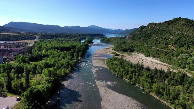 Drone shot, drone video, drone flight, aerial view, flight over the river Rio Cinca and Ara, forests, islands, wide view of the mountains of the Pyrenees, Ainsa, province Huesca, Aragon, Spain