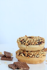 chocolate and peanut donuts close up, space for tex