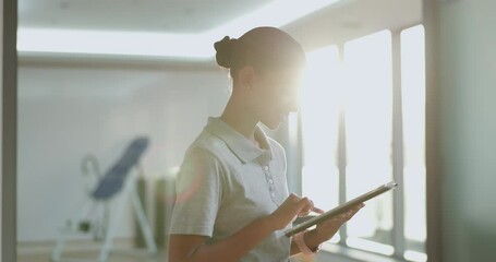 Physiotherapist, online or woman with tablet on fitness app planning workout routine or rehabilitation schedule. Technology, typing or chiropractor on application for sports training research or news