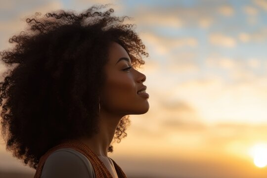 Young Woman Looking Up At The Sky At Sunset