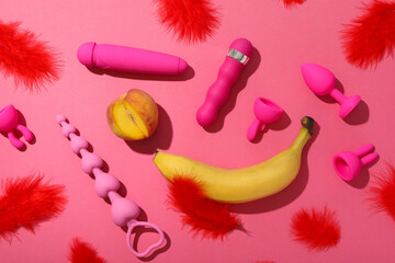 Collection of sex toys, on a pink background.