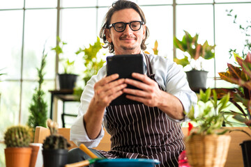 Handsome confident senior man relaxing use technology of tablet computer while sitting on chair.elderly creative coworkers business people working and use tablet at home