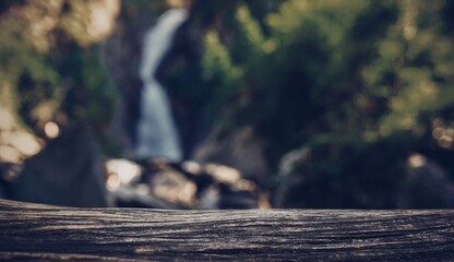 Wooden surface on the background of waterfall 