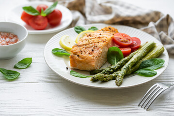 Baked Delicious salmon, green asparagus on  plate