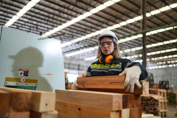 Fototapeta na wymiar Industrial factory employee working in wooden manufacturing industry