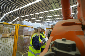 Worker are working at lumber yard in Large Warehouse. Worker are  working.on woodworking machine,...