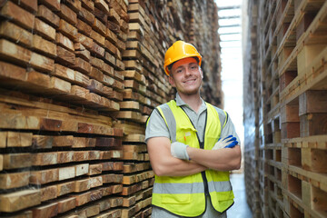 Worker are working at lumber yard in Large Warehouse. Worker are  working.on woodworking machine,...