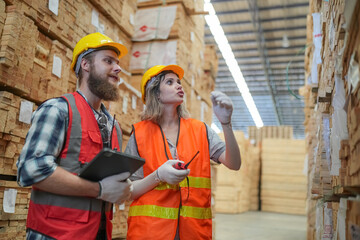 Worker are working at lumber yard in Large Warehouse. Worker are  working.on woodworking machine,...