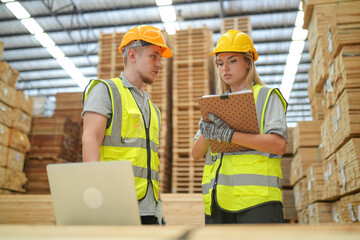Warehouse worker working at lumber yard in Large Warehouse. Worker are  Inventory check at Storage...