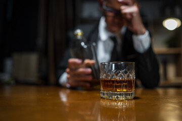 Businessmen in suits drinking whiskey