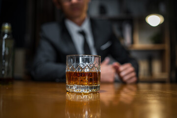 Businessmen in suits drinking whiskey