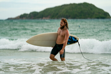 Happy friends with surfboards on the beach