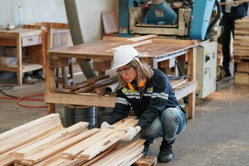 Worker are working at lumber yard in Large Warehouse. Worker are  working.on woodworking machine, lumber and Inventory check at Storage shelves in lumberyard.