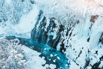 Shirahige Waterfall with Snow in winter, Biei river flow into Blue Pond. landmark and popular for...