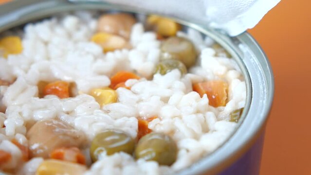 close up of can food with rice and vegetables 