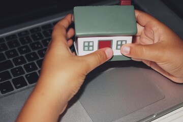 House model hold in two hands . Conceptual photo.