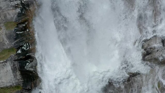 Close-up aerial view of Cascata del Toce waterfall plunging down cliff, Italy