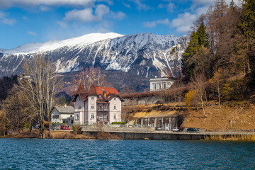 Bled, Slovenia - Lovely hotel at Lake Bled with Julian Alps at background on a sunny winter day. Blue sky and clouds