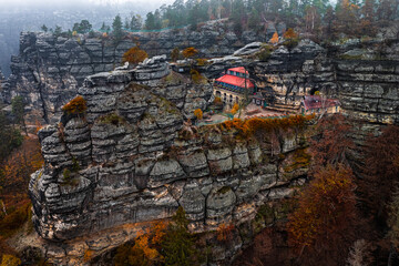Hrensko, Czech Republic - Aerial view of the famous Pravcicka Brana (Pravcicka Gate) in Bohemian Switzerland National Park, the biggest natural arch in Europe on a foggy autumn day with autumn foliage