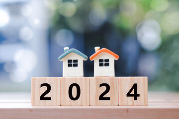 2024 New year with two house model on 2024 wooden blocks number. New year property investment...