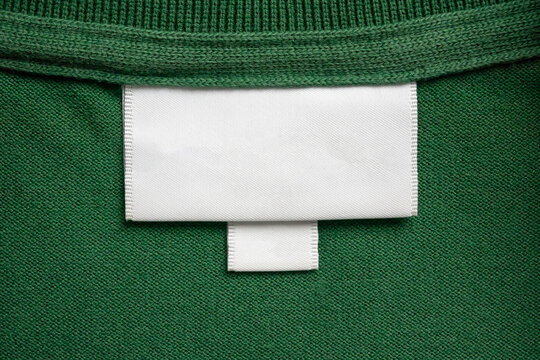 Blank white laundry care clothes label on green shirt fabric texture background - Powered by Adobe