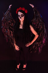 woman look as angel Death with red  roses wreath full length sho