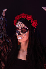 woman look as angel Death with red  roses wreath  closeup