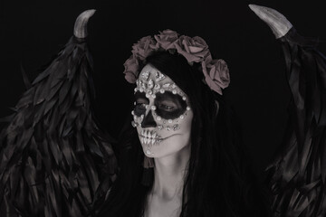 woman look as angel Death with red  roses wreath  closeup