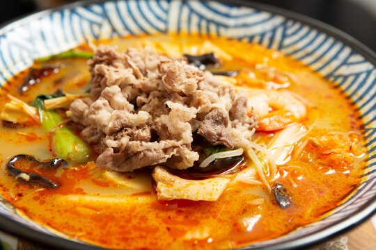 skewered vegetables and meat cooked in a hot and spicy soup