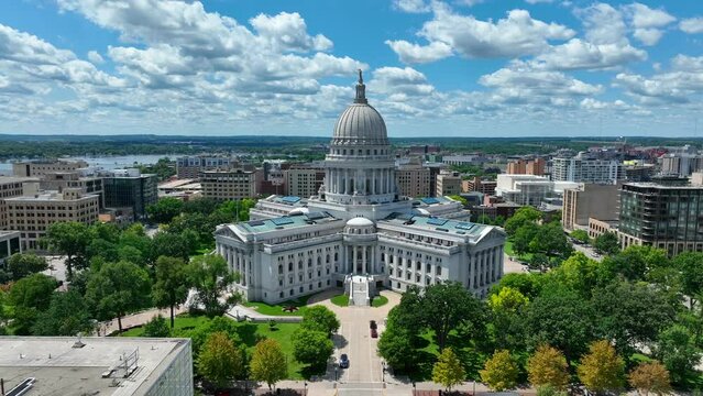 Capitol building of Wisconsin. Aerial reveal of Madison, WI capital city and grounds on beautiful summer day.