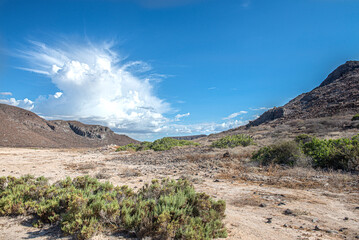 Baja Califronia Sur landscape, beautiful clouds in a blue sky with mountains rocks and vegetation in the desert. Horizontal